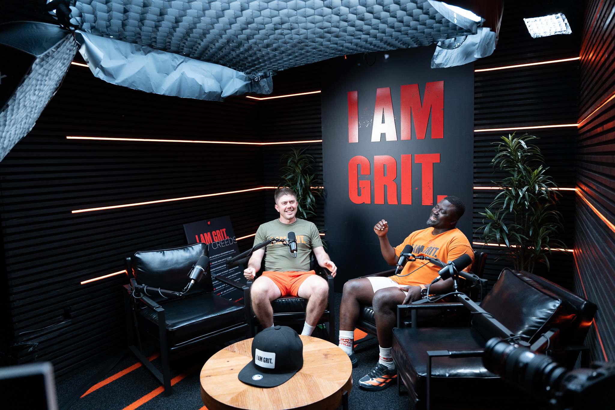 Michael Tetteh and Stephen Anderson beneath the I AM GRIT banner